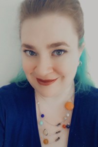 image of 33 year old woman wearing a necklace of the solar system
